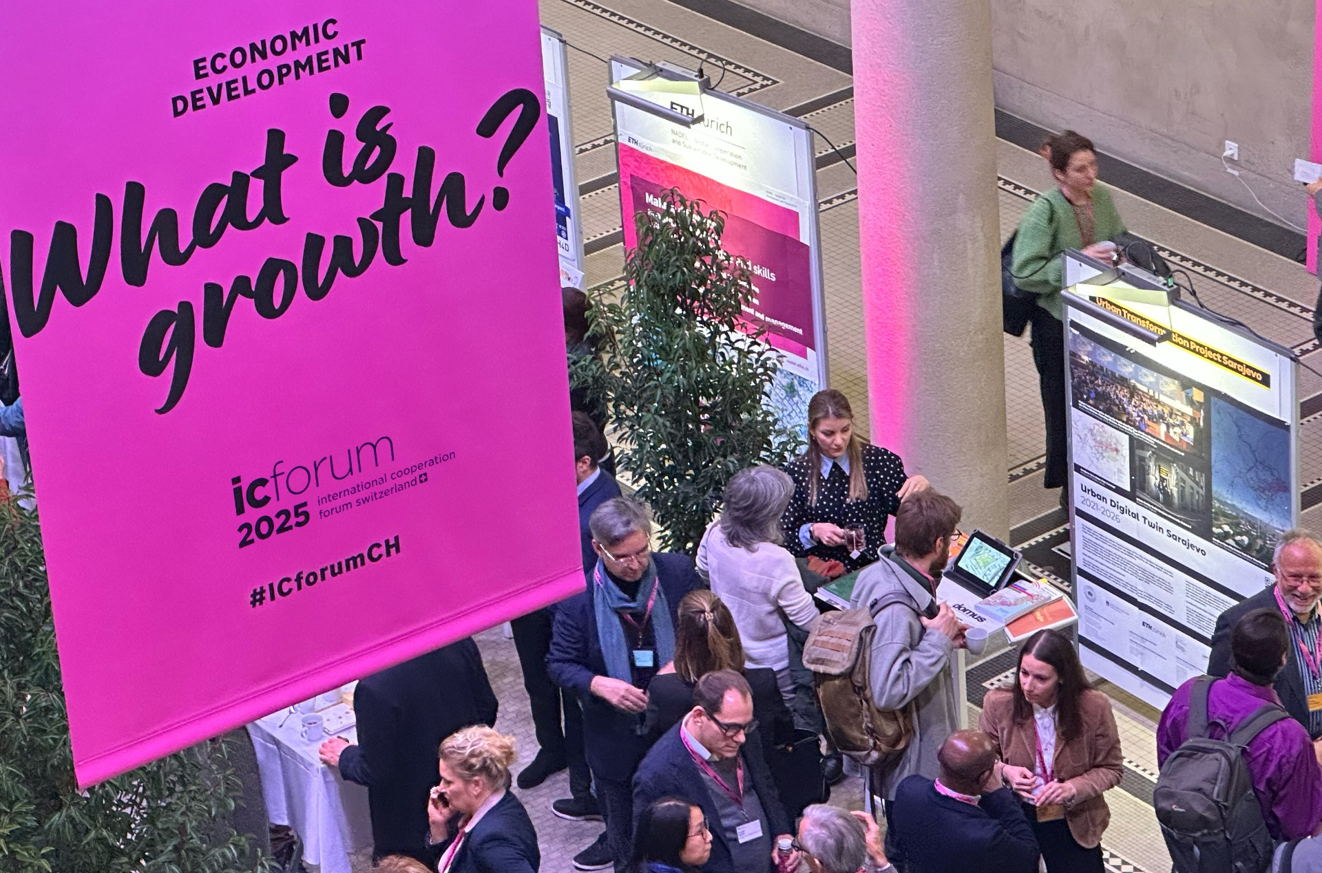 People talking to each other and a banner of Urban Digital Twin Sarajevo at the IC Forum 2025 Marketspace in the ETH Main Building Säulenhallen, Credit: Dr. Michael Walczak, ETH Zurich Klumpner Chair of Architecture and Urban Design